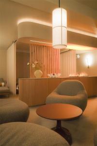 a room with two chairs and a table and a table at Best Western Plus John Bauer Hotel in Jönköping +44 photos