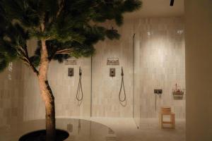 a bathroom with a shower with a tree in it at Best Western Plus John Bauer Hotel in Jönköping