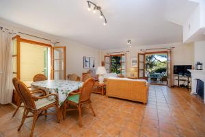 a living room with a table and chairs and a couch at Cala Pi Two in Cala Pi