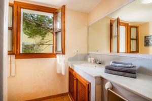 a bathroom with a sink and a mirror at Cala Pi Two in Cala Pi +19 photos