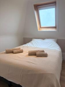 a bedroom with a bed with two pillows on it at Maison Lavandelle in Middelkerke