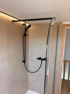 a shower in the corner of a room at Maison Lavandelle in Middelkerke +15 photos