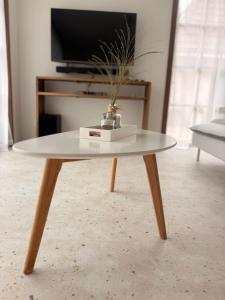 a coffee table with a vase on top of it at Maison Lavandelle in Middelkerke