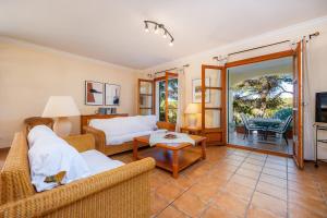 a living room with two couches and a table at Cala Pi Two in Cala Pi