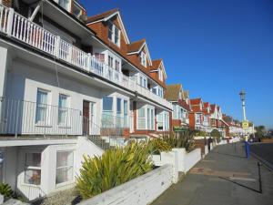 a row of houses with balconies on a street at Seabreeze Apartment in Eastbourne