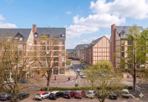 a city with cars parked in a parking lot at B&B HOTEL Troyes Centre in Troyes