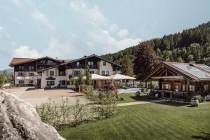 a resort with a large yard and a building at Hotel loj - our kind of place in Flachau