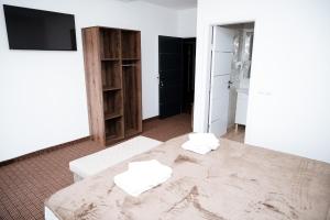 a room with a bed with two towels on it at Villa Palma - With Free Parking in Mostar +92 photos