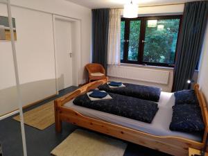 a bedroom with a large wooden bed and a window at Gästehaus am Sternberg in Gomadingen