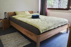 a bed with a blue bag sitting on top of it at Gästehaus am Sternberg in Gomadingen +17 photos