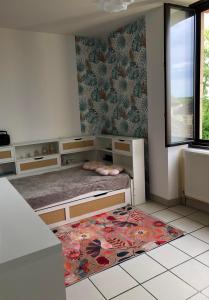 a bedroom with a bed and a rug on the floor at ROMELLA's ROOM FAMILY in Saint-Projet