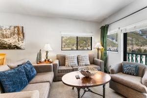 a living room with couches and a table at Greens at Copper #314 in Copper Mountain