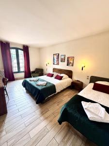a hotel room with two beds in a room at L'Imprevisto in Grasse