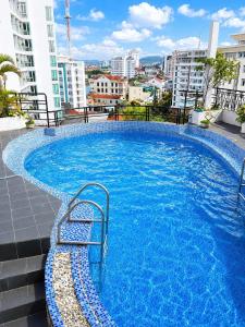 a large blue swimming pool on top of a building at The Sunriver Boutique Hotel Hue in Hue