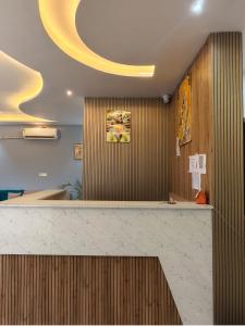 a lobby with a counter with a yellow ceiling at Dev Hotel & Restaurant in Vrindāvan