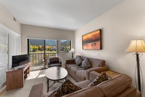 a living room with a couch and a tv at Greens at Copper #217 in Copper Mountain