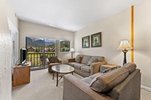 a living room with a couch and a tv at Greens at Copper #217 in Copper Mountain