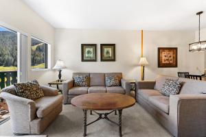 a living room with couches and a table at Greens at Copper #217 in Copper Mountain