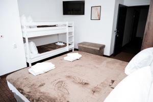 a room with a bed and a table with towels at Villa Palma - With Free Parking in Mostar