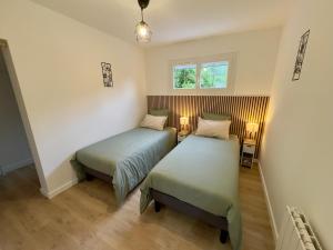 a room with two beds and a window at Gîte Chez Armande in Surfonds
