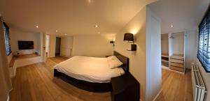 a bedroom with a white bed in a room at B&B The Parklane Retreat in Schoten +7 photos
