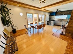 a large living room with a table and chairs at K'sVILLAGE 平砂浦ハウスＳ in Tateyama