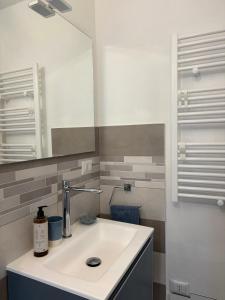 a bathroom with a sink and a mirror at Urban House in Nuoro