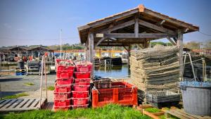 a group of containers sitting next to a dock at Chambres Du Petit Bonheur in Biscarrosse