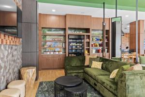 a living room with a green couch and a table at The Wills Hotel in Cumberland +28 photos