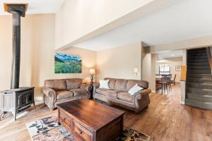 a living room with two couches and a fireplace at Rockridge #51 in Breckenridge