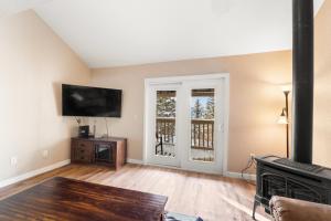 a living room with a flat screen tv and a fireplace at Rockridge #51 in Breckenridge