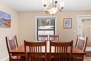 a dining room with a wooden table and chairs at Rockridge #51 in Breckenridge +17 photos