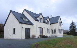 a large white house with a black roof at Seafar Bed & Breakfast in Portree