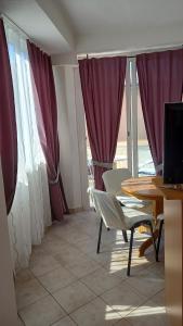 a room with a table and chairs and a window at Slavica Bunić, Apartments in Supetarska Draga