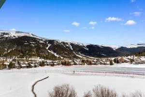 a snow covered valley with a village and mountains at Greens at Copper #217 in Copper Mountain +17 photos