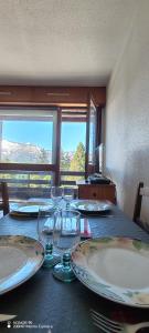 a table with plates and wine glasses on it at L'Ancien Temps in Ustou +21 photos