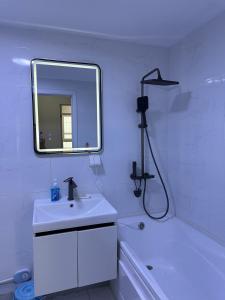 a white bathroom with a sink and a mirror at Newly built Modern 2 BR apartment in Ulaanbaatar +18 photos