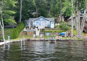 a house on the water with a boat in the water at Lakeside Haven, Tranquil Waters in Holland