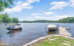two boats are docked at a dock on a lake at Lakeside Haven, Tranquil Waters in Holland +34 photos