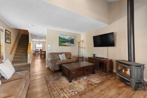 a living room with a fireplace and a tv at Rockridge #41 in Breckenridge
