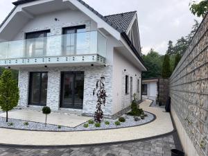 a white brick house with a driveway at Villa White Stone in Starý Smokovec