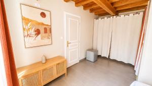 a living room with a table and a window at Chambres d’hôtes A Casa Di Marigaby in Barbaggio +16 photos