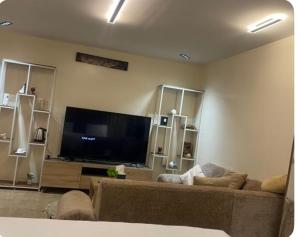 a living room with a couch and a flat screen tv at نزل بسمة الأبداع in Abha +9 photos