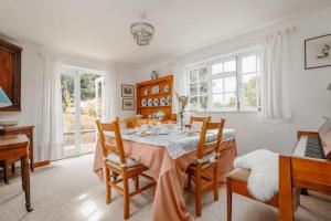 a dining room with a table and chairs at Cheesemans Cottage in Grimstone