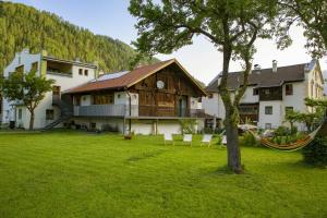 a house with a hammock in front of a yard at Stadlchalet in Ried im Oberinntal