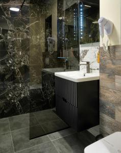 a bathroom with a sink and a shower at Piata Unirii Central Apartments in Iaşi +74 photos