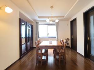 a dining room with a wooden table and chairs at 禮 -Rei House- in Muromimachi +53 photos