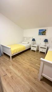 a bedroom with two beds and two night stands at Vicko villa in Seget Vranjica
