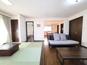 a living room with a couch and a table at 禮 -Rei House- in Muromimachi