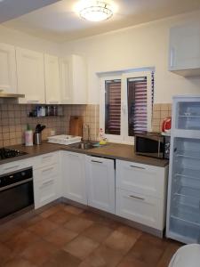 a kitchen with white cabinets and a counter top at Vicko villa in Seget Vranjica +22 photos